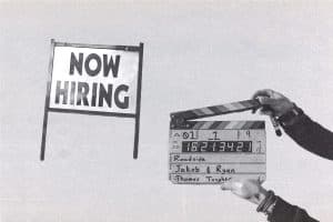 Collage featuring a “Now Hiring” sign next to hands holding a film slate.