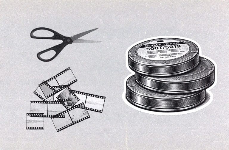 scissors cutting 35mm film next to a stack of Kodak 500T film illusrtation canisters