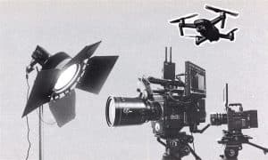 Film production equipment including cinema camera, lighting, and illustration of a drone.